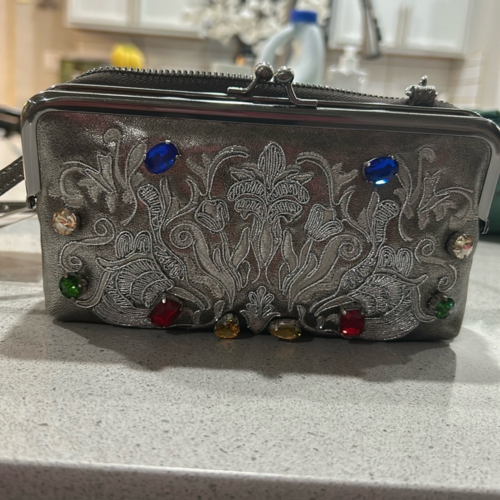 A beautiful crossbody with a lat space. Brand new.
